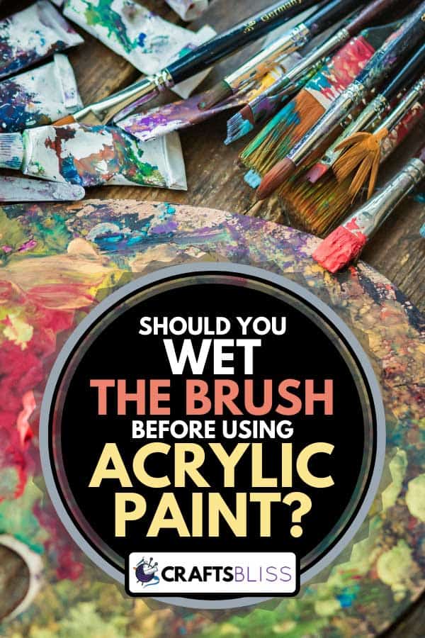 Paintbrush, acrylic paint and artist's palette on a wooden table, Should You Wet The Brush Before Using Acrylic Paint?