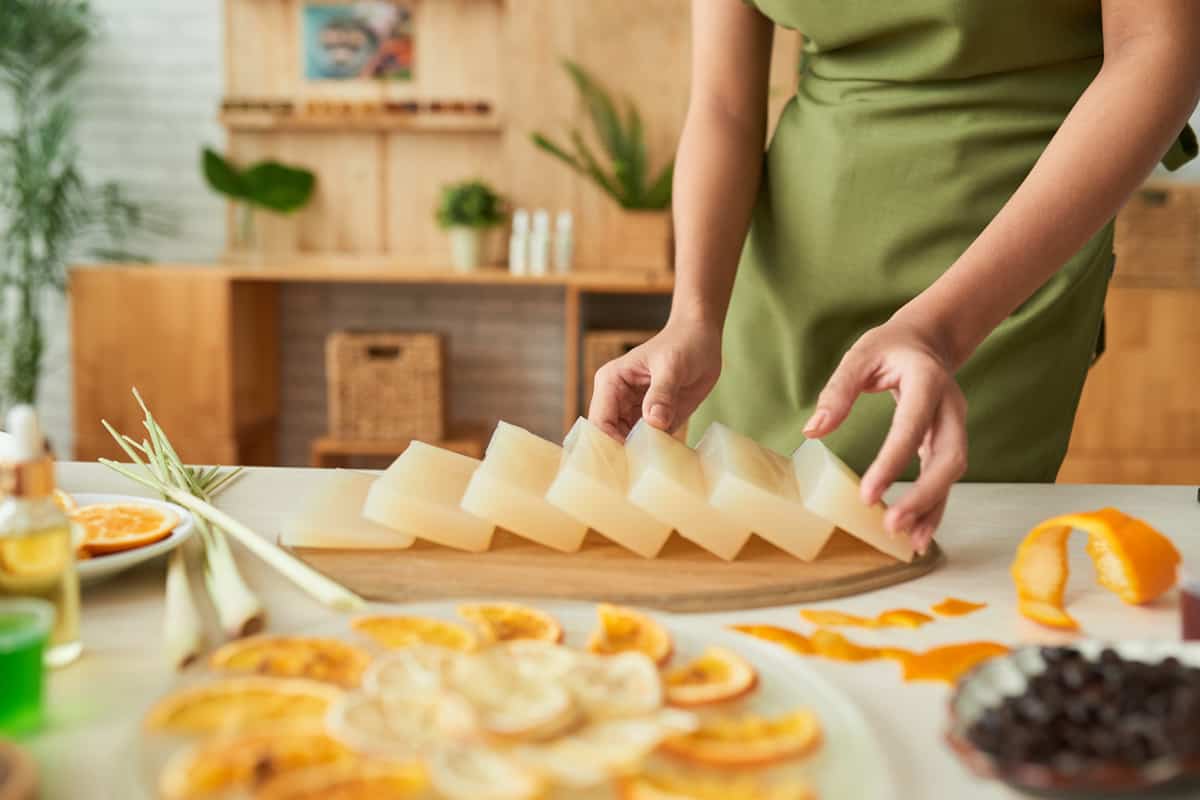 A woman arranging her soap molds on a table