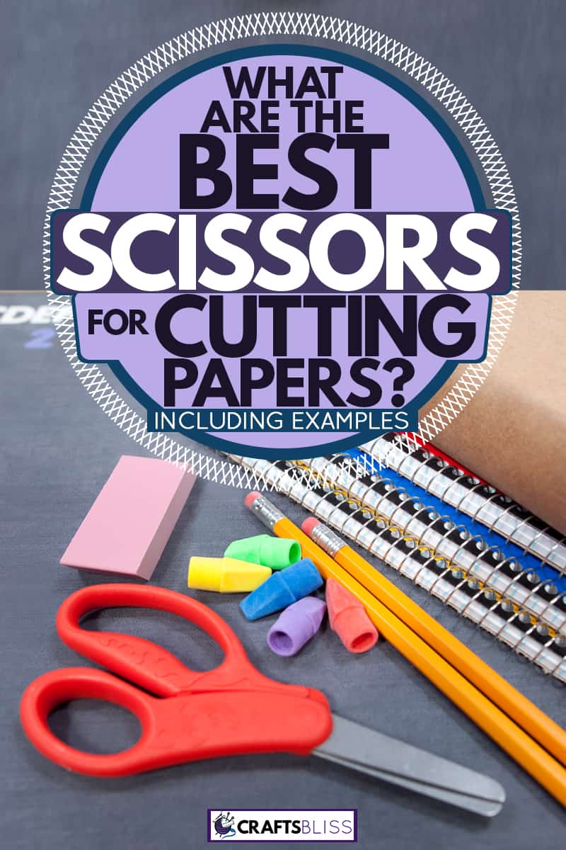 A safety scissor placed next to papers and pencils at a teachers desk, What Are The Best Scissors For Cutting Paper? [Inc. Examples]