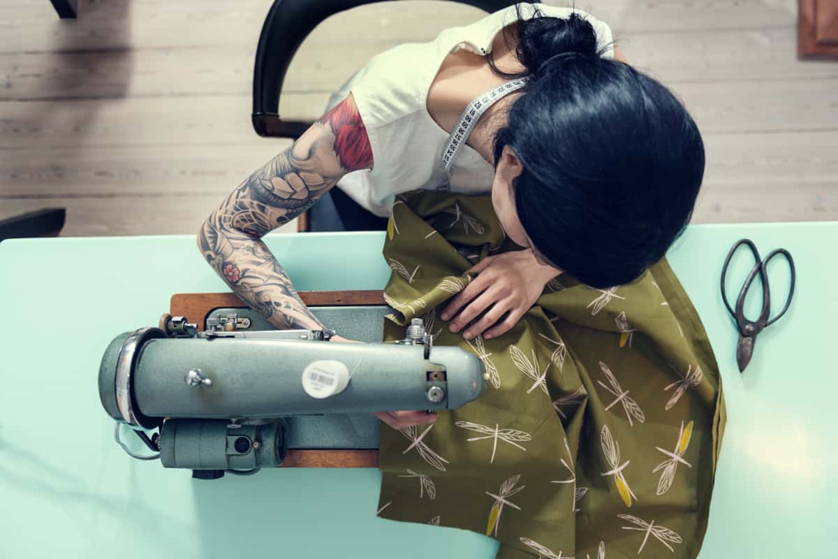 A professional dress maker creating a work of art dress using her trusty sewing machine