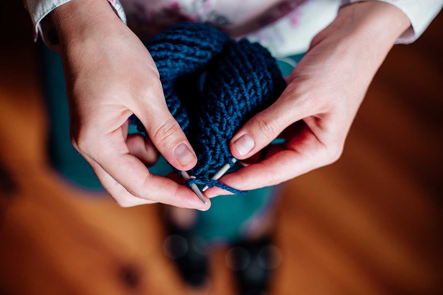 Picture of a woman knitting woolen clothes