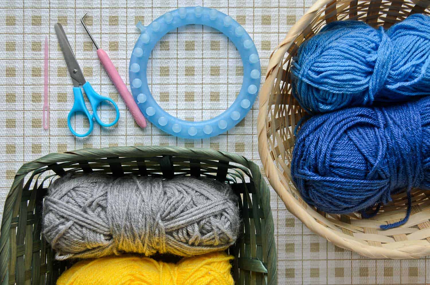 Yarns in baskets and knitting tools