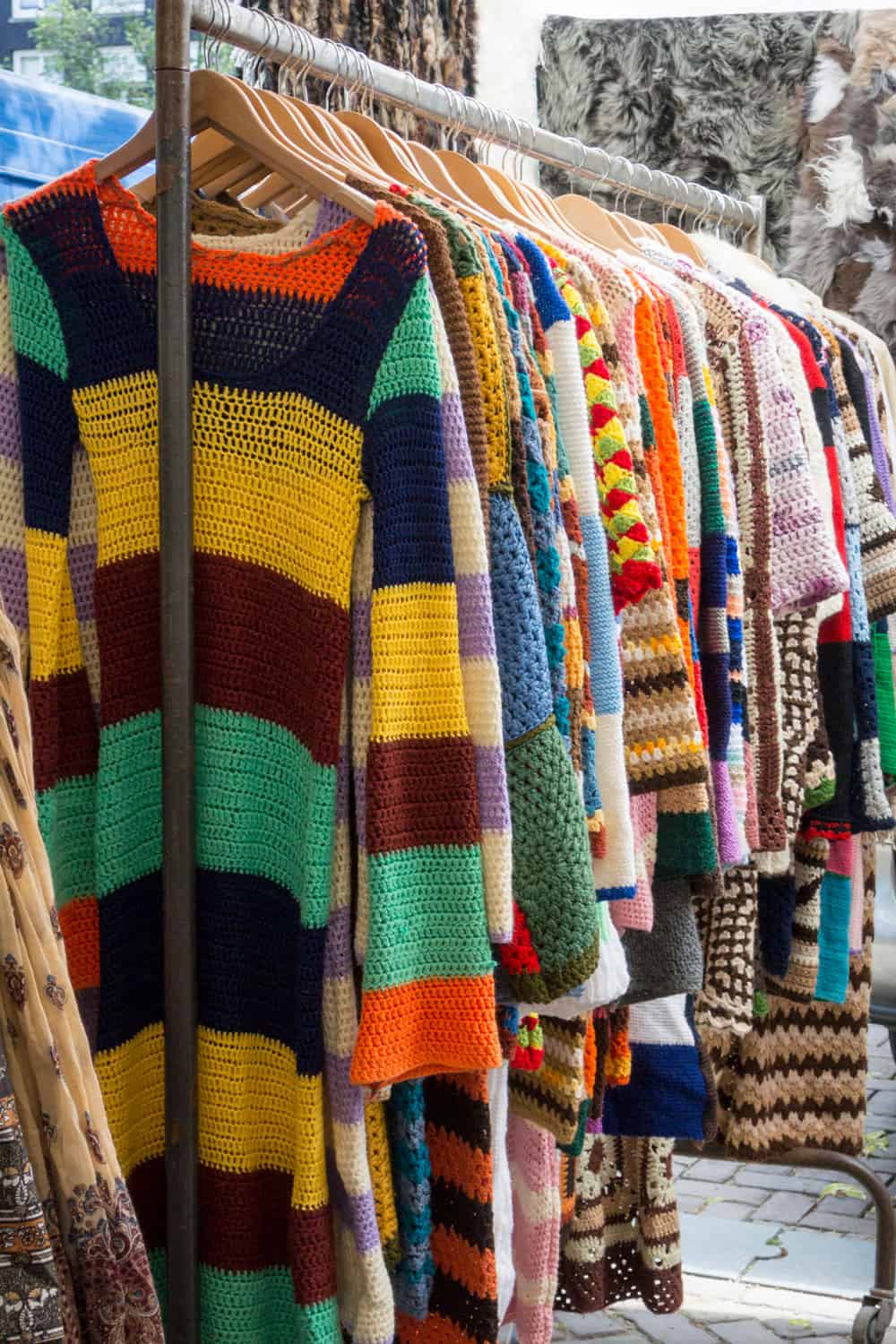 A rail of colourful crocheted clothes hanging