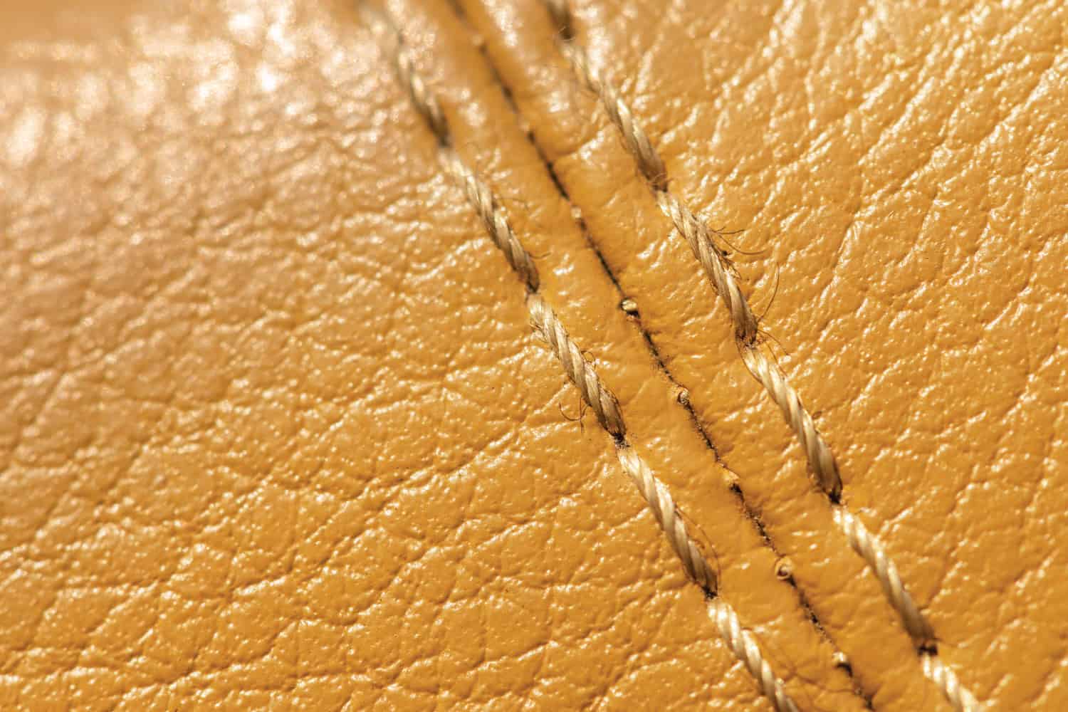 Beige orange faux leather stitching in the car interior