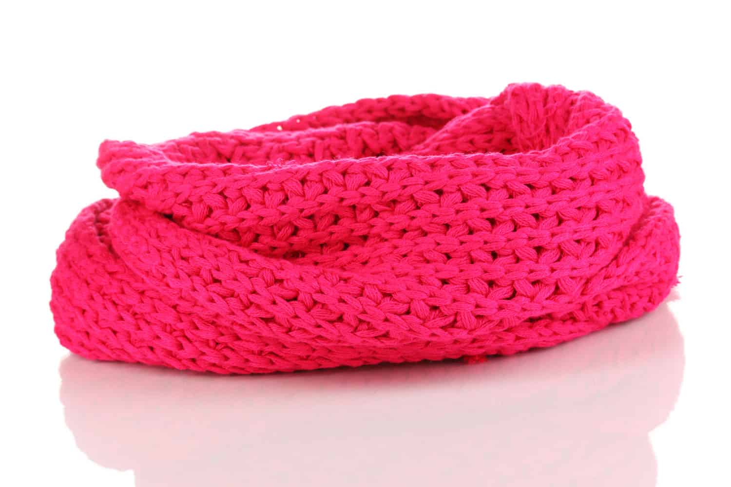 A gorgeously stitched light pink scarf on a white background