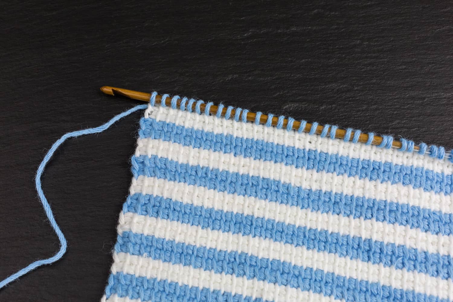 Blue and white striped crocheted scarf