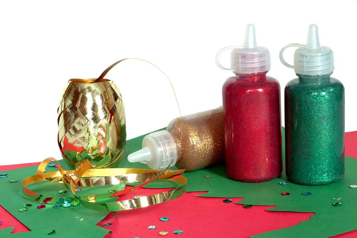 Different colors of glitter glue for making a small Christmas note