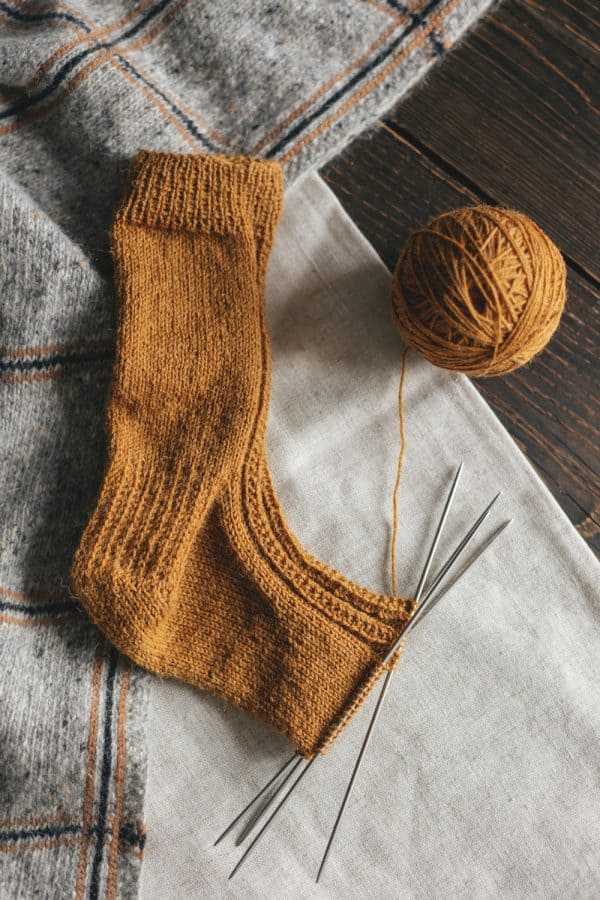 A brown colored yarn matching a long brown sock 