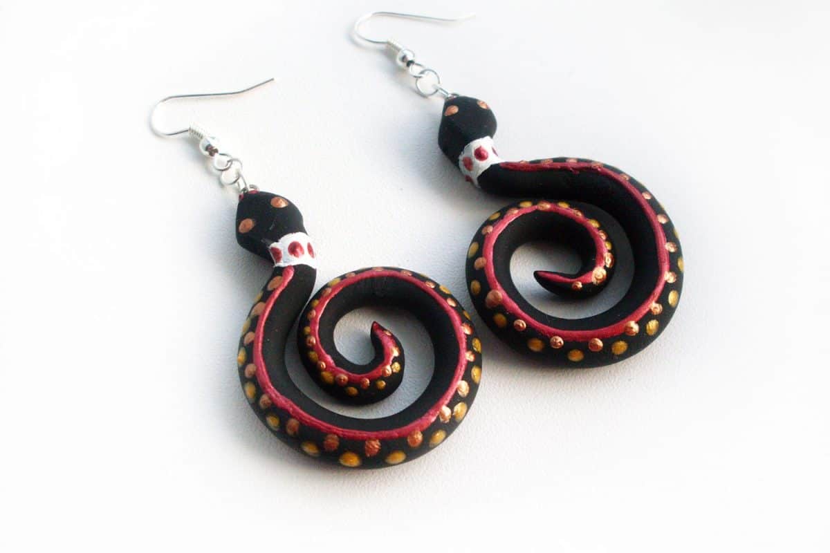 A pair of polymer octopus earrings on a white background