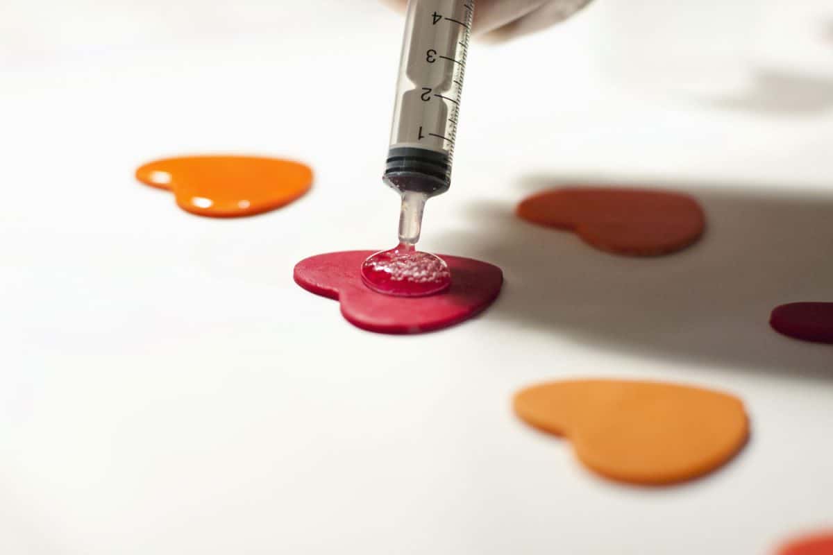 A polymer artist putting a gloss finish on her polymer artwork