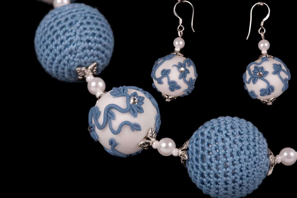 A small bead bracelet and earrings decorated in blue polymer clay