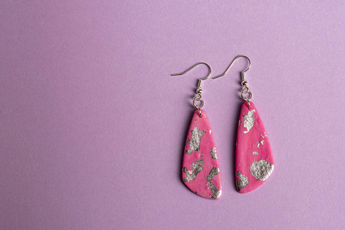 A pair of pink and silver earring on a purple background, 21 Fantastic Polymer Clay Bead Ideas