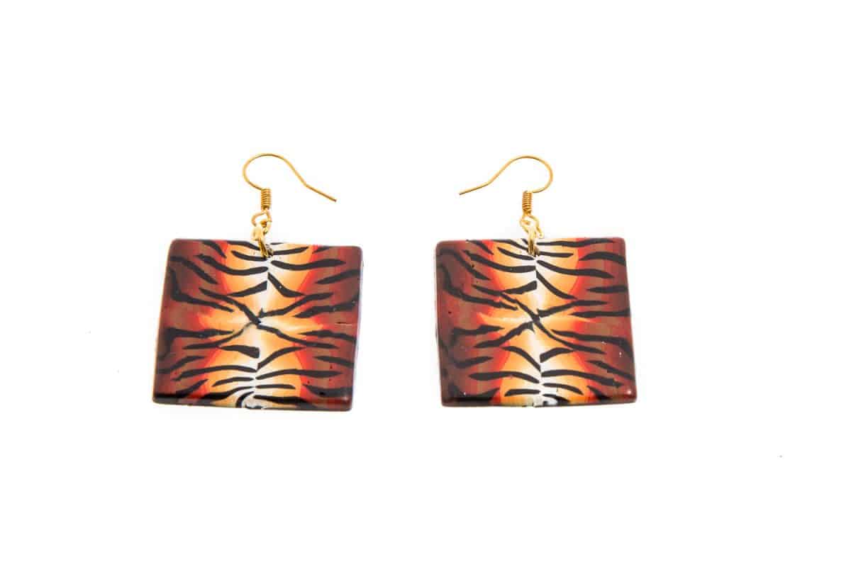 Tiger skin themed earrings on a white background