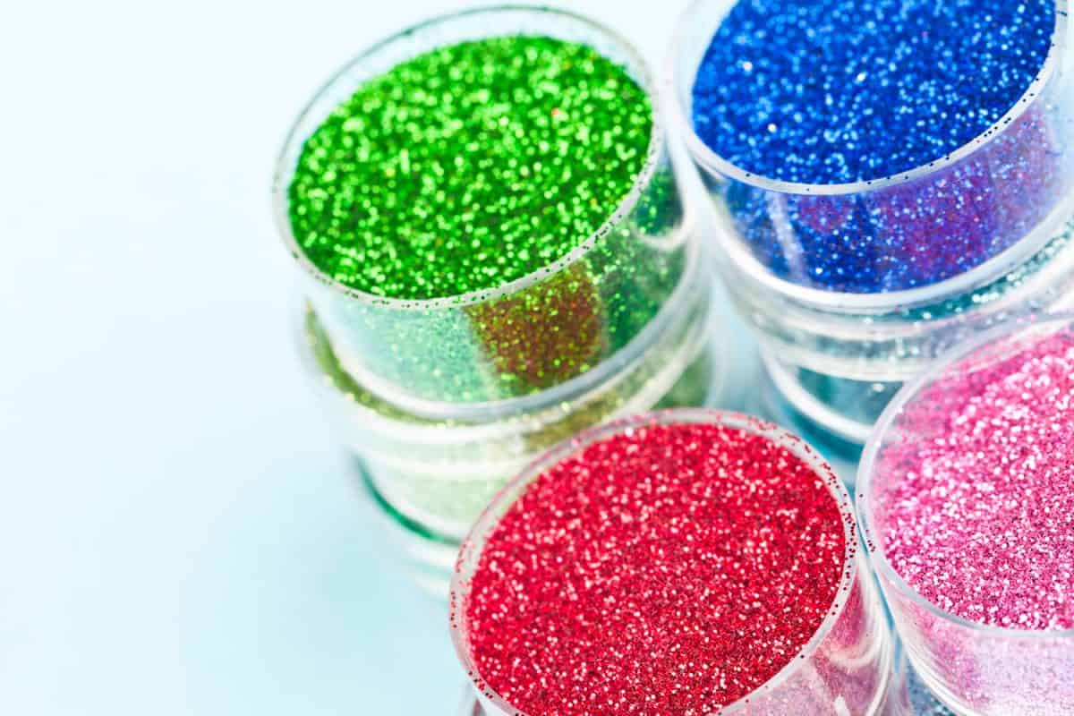 Different colored glitters on a white background