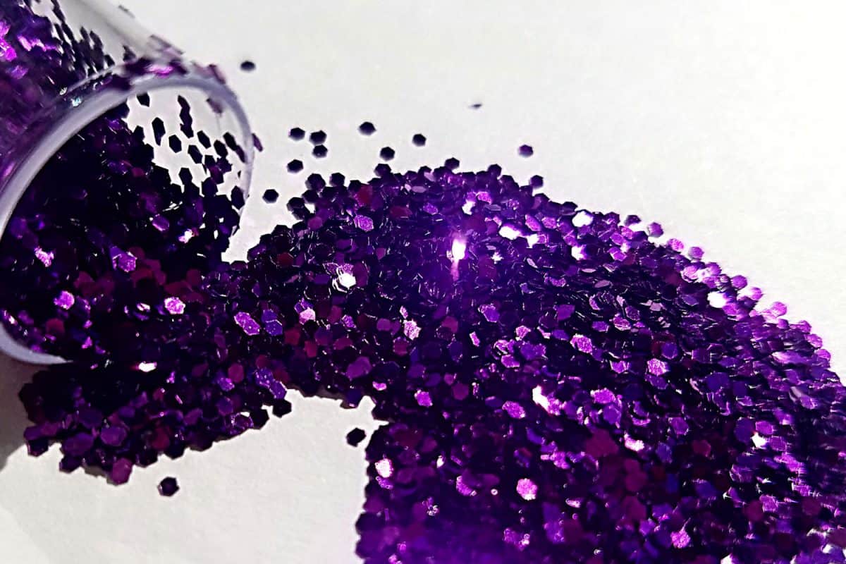 Purple glitter poured out of a small container
