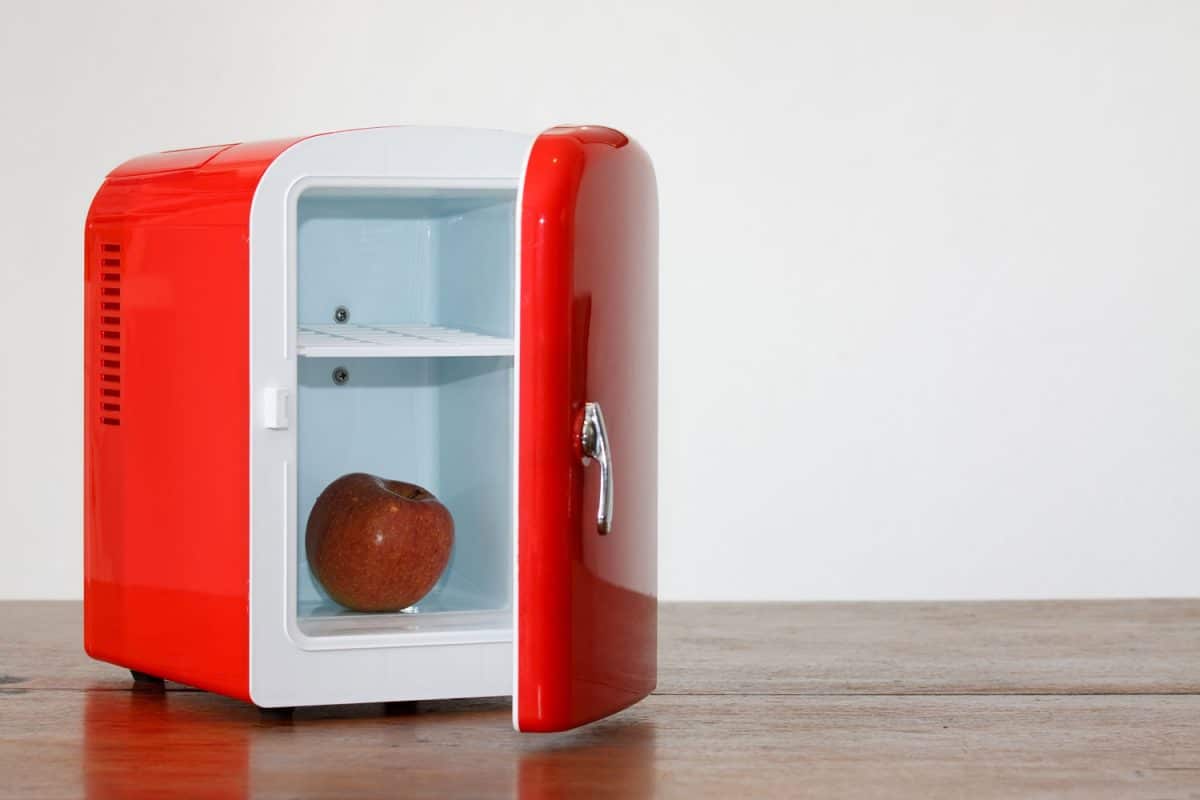 A red mini fridge on the table
