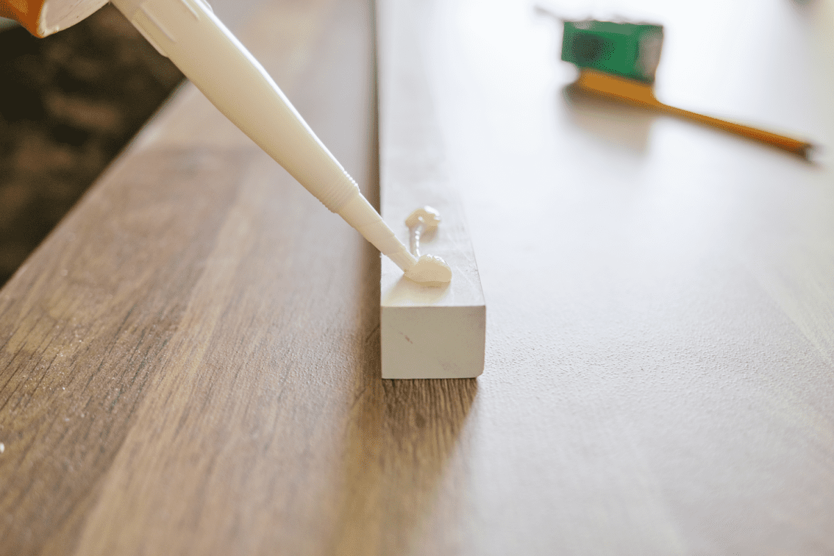Putting wood glue to a small 1x1 wooden work piece