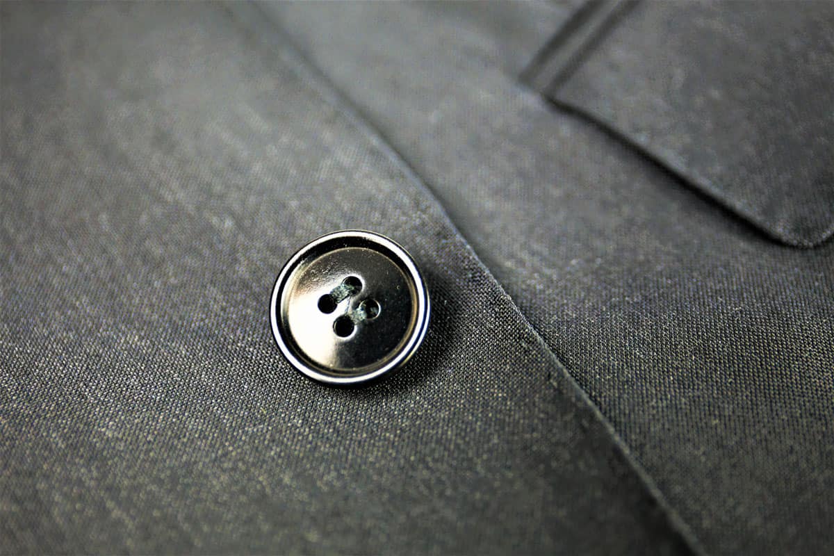 An up close photo of a black suit button