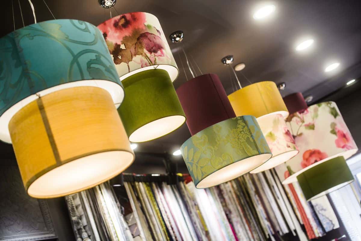 The green fabric lampshade at the magazine. colorful, decorative, electrical, furniture, illumination, lamp, lampshade, style, textile, abstract background, hanging lamp, interior design.