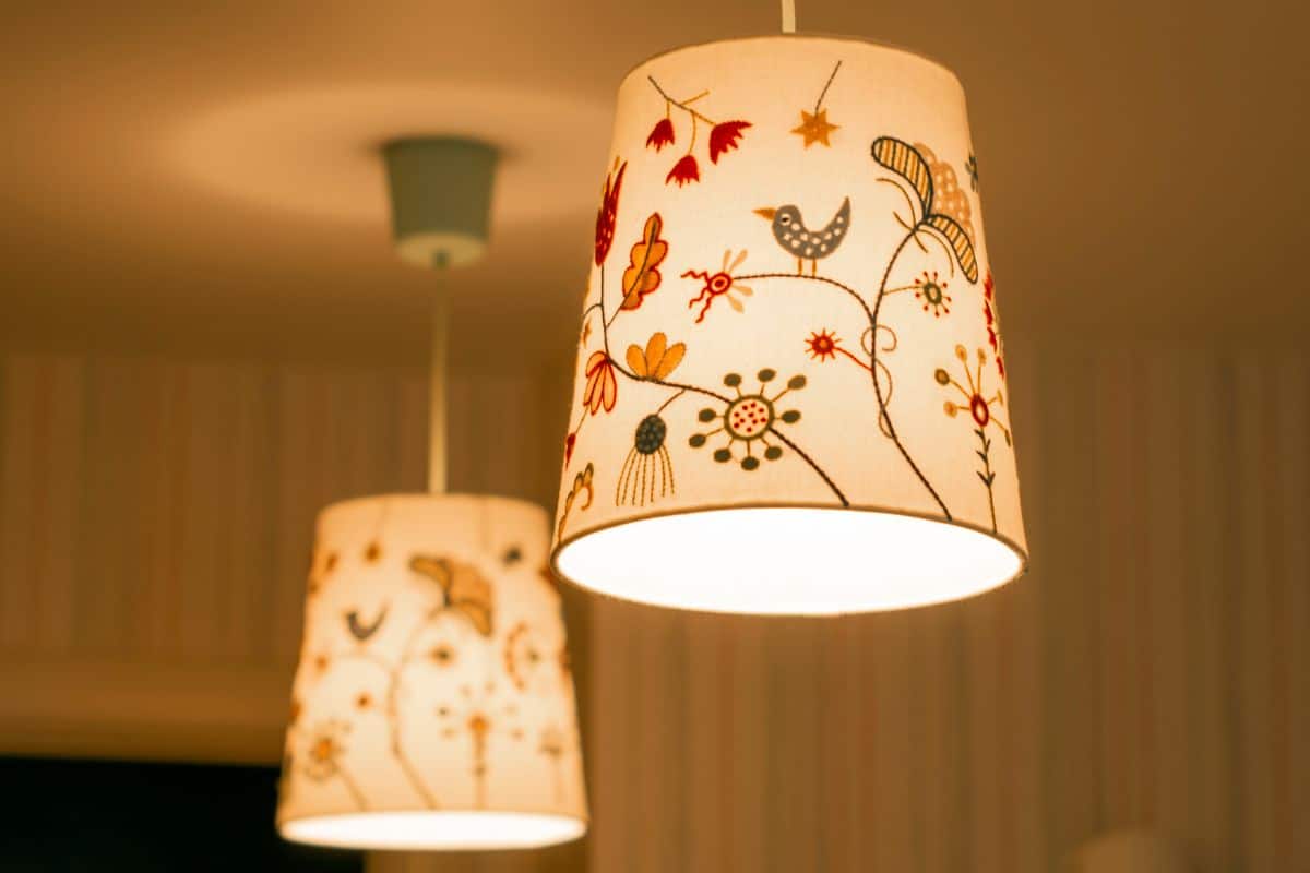 cozy embroidered lampshades with lamps and soft light hang in the house