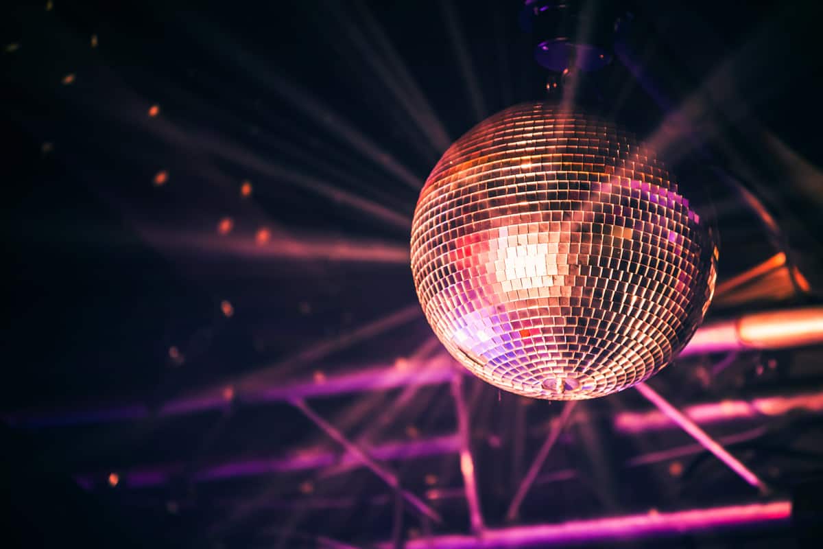 An orange disco ball shining and bringing vibe to a club