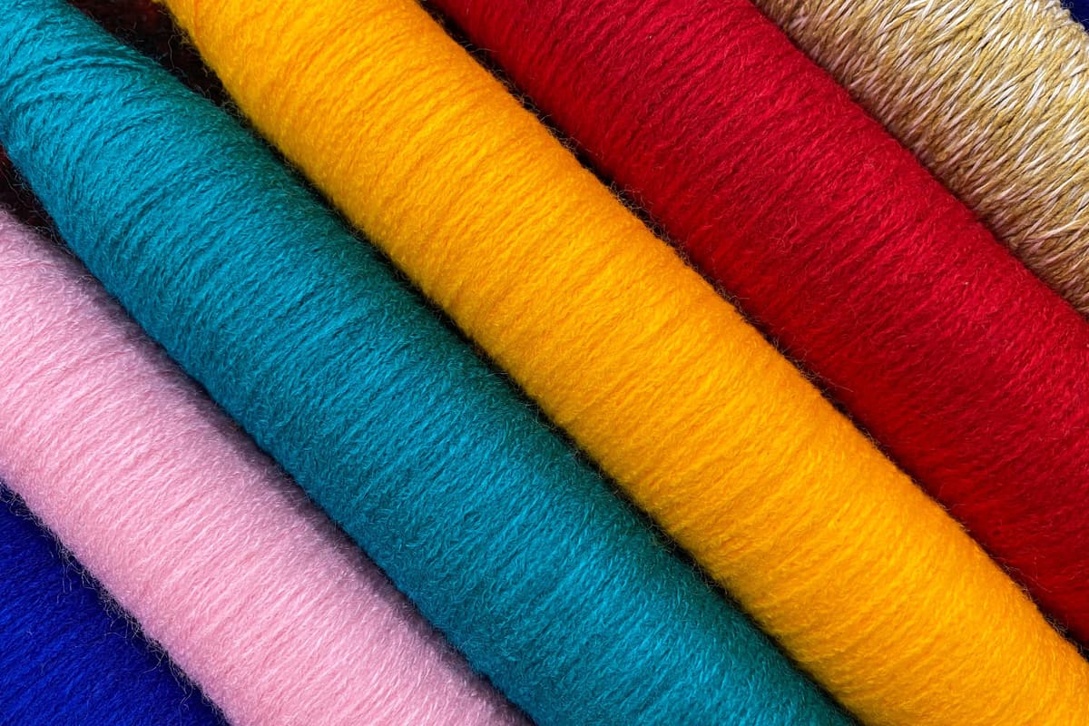 Colorful threads. Yarn. Bobbins with yarn. Fabric. Sewing threads