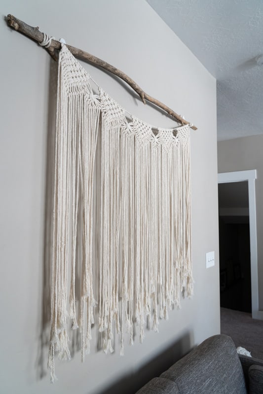 Large macrame wall hanging from natural stick minimal decor